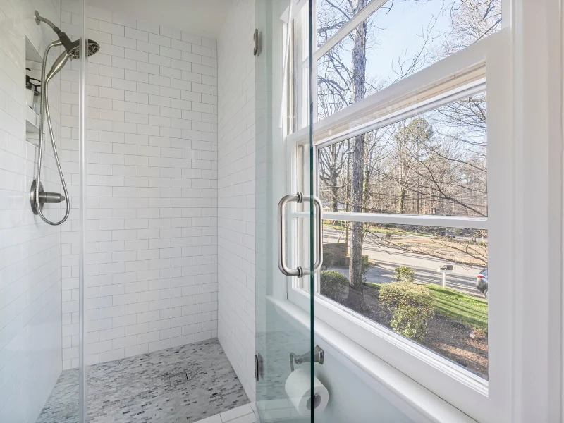 Modern bathroom with glass shower door, illustrating leaking shower door repairs.