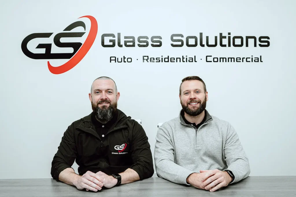 The owners of Glass Solutions get together for a photo. This Raleigh-based group repairs and installs commercial, residential, and auto glass.