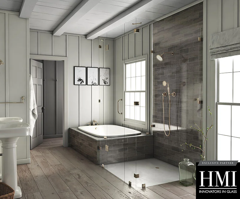 A frameless glass shower door is pictured in a modern bathroom with a bathtub. 