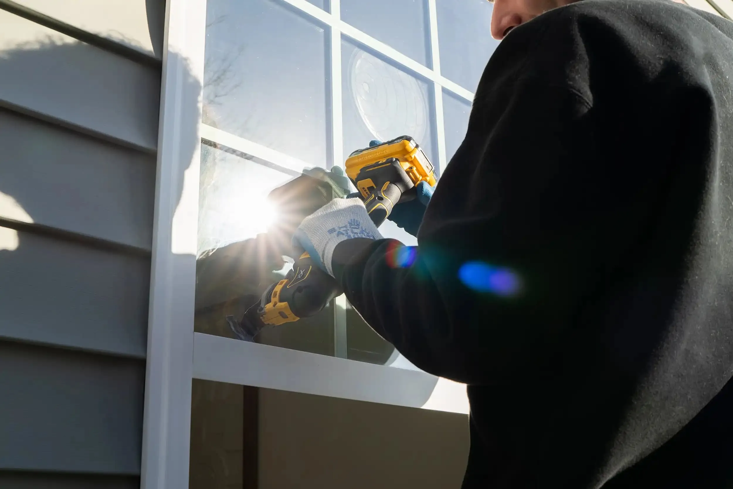 A man provides expert window seal repair in Cary, NC.