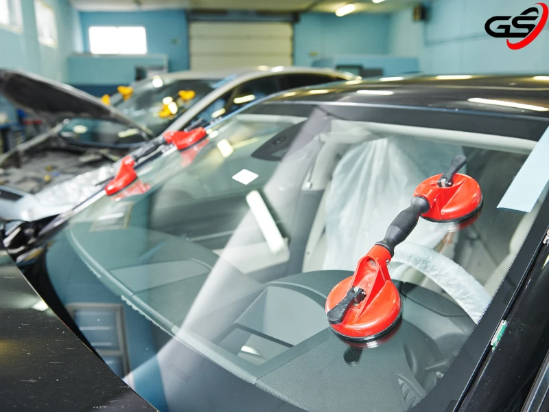 Car's windshields being cured after a windshield replacement service.