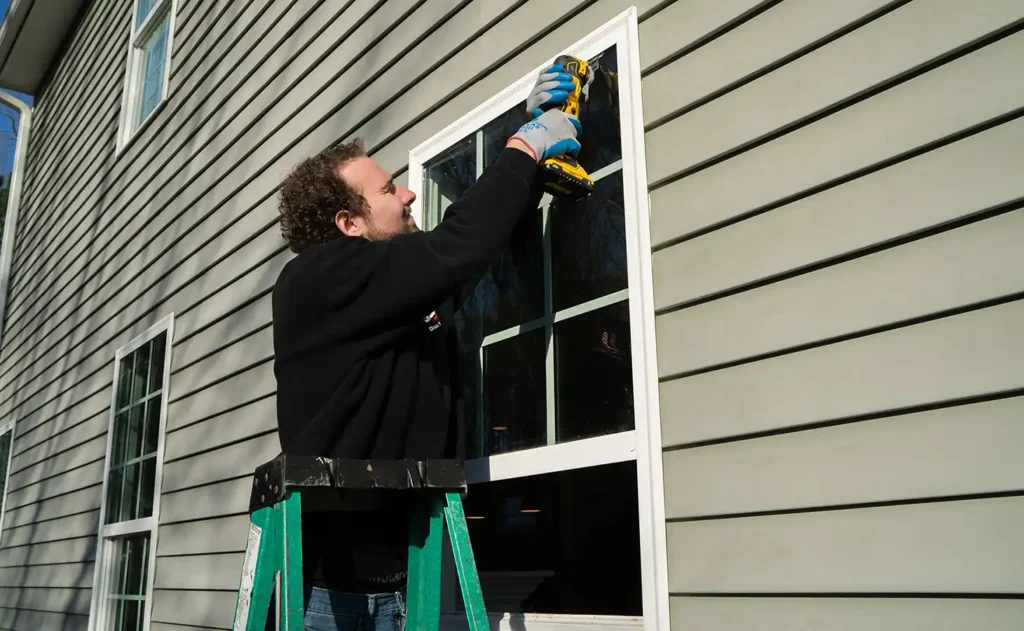 A professional seals a window by providing window replacement in Fuquay Varina.