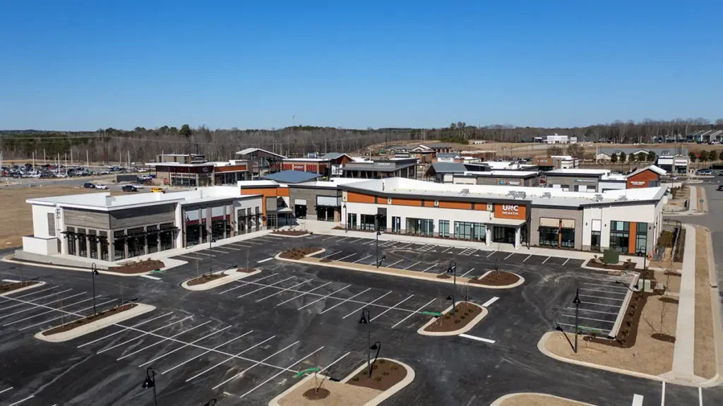 A shopping center with new glass storefronts installed by Glass Solutions, a glass contractor.