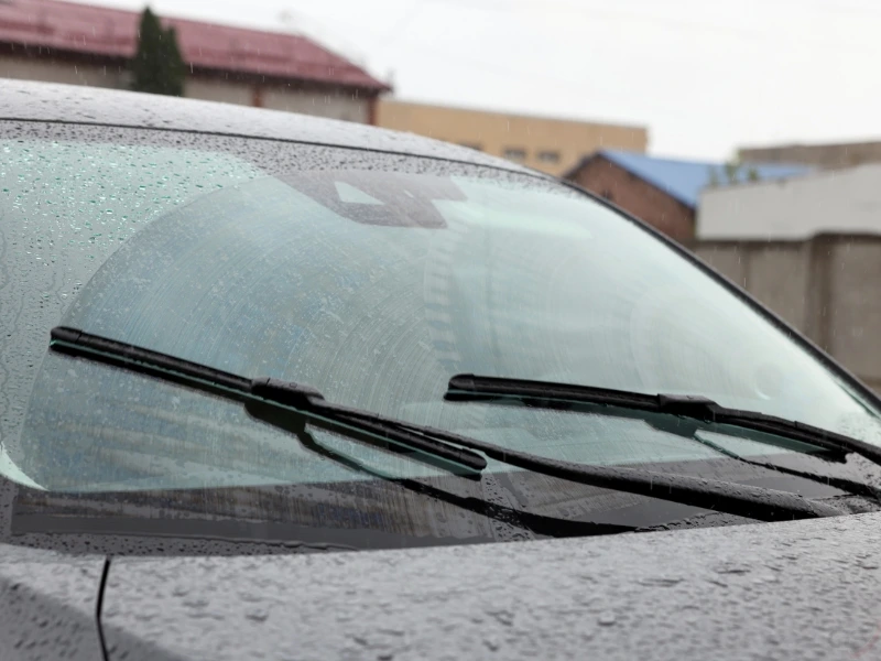 A car in the rain, highlighting the importance of windshield camera calibration.